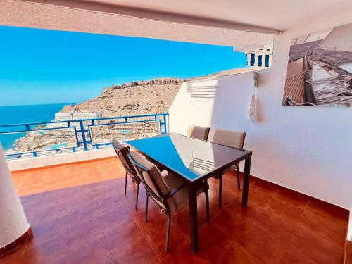 a dining room with a table and a view of the ocean at Sunset Taurito in Taurito