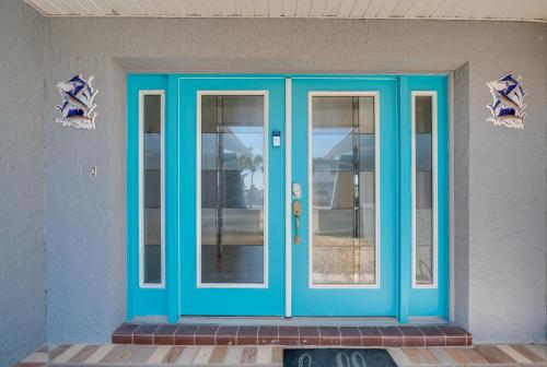 a blue door on the side of a building at Canal and Gulf Views Spacious Hudson Home in Hudson