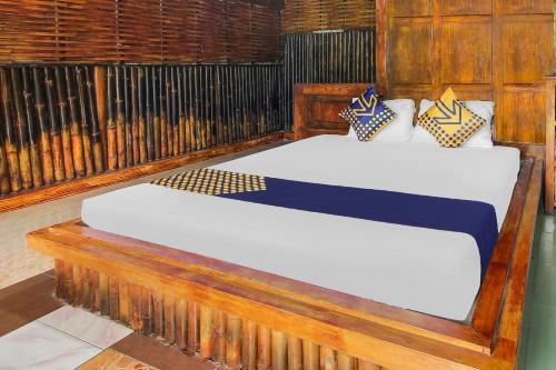 two beds in a room with a fence at OYO 92083 Lailik Gilang Guesthouse in Watukarung