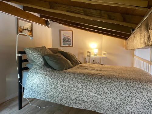a bedroom with a large bed with a wooden ceiling at Gure Txokoa in Cerain