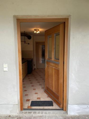 a door leading into a kitchen with a tile floor at Zum Fröhlich in Großweil