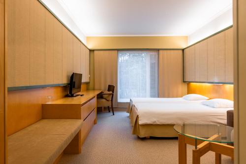 Postel nebo postele na pokoji v ubytování Saaremaa Rannahotell ' Beach Hotel