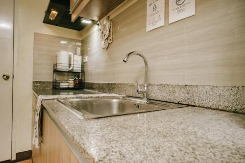 a kitchen with a sink and a counter top at AR09 HBRentals 1BR Smart Unit in Davao City