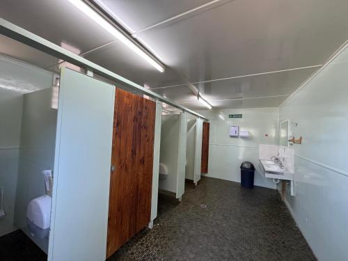 a room with a bathroom with a toilet and a door at Hay Caravan Park in Hay