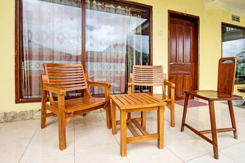 a group of chairs and a table in a room at Hotel O Ujung Samalas HomestayNearLapangan Sembalun Bumbung in Labuan Lombok