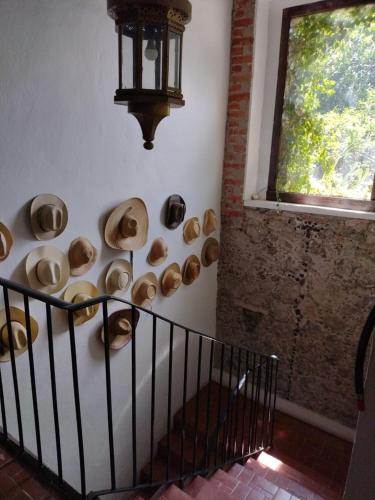 a room with a bunch of bowls on the wall at Posada Colibri - Hotel & Spa in San Juan Teotihuacán