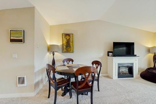 a living room with a table and chairs and a tv at Lighthouse Views in Westport