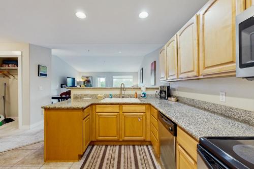 a kitchen with wooden cabinets and a sink at Lighthouse Views in Westport