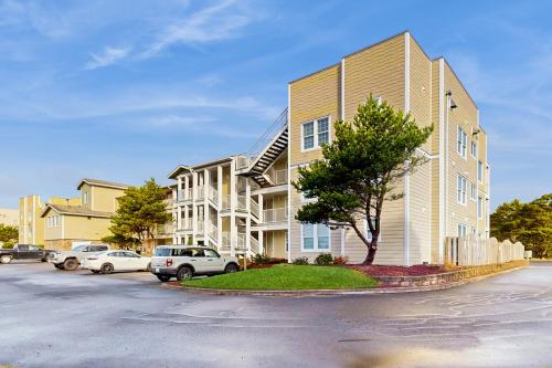 a apartment building with cars parked in a parking lot at Lighthouse Views in Westport