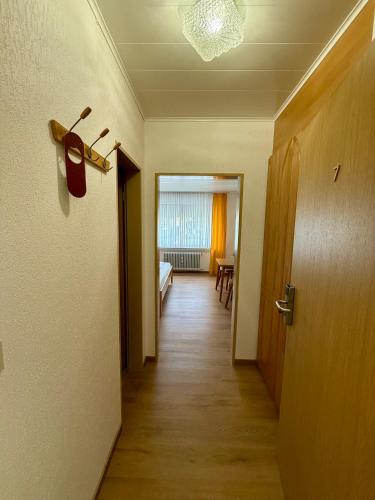 a hallway with a door and a room with a table at Weinhaus Hirschen Bruttig in Bruttig-Fankel