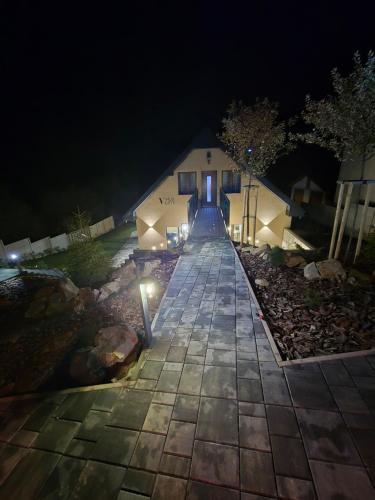 a walkway leading to a building at night at Vila LiMi in Oščadnica