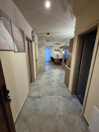 a hallway leading to a room with a living room at Vila LiMi in Oščadnica