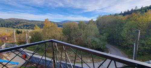 a balcony with a view of a road and trees at Vila LiMi in Oščadnica