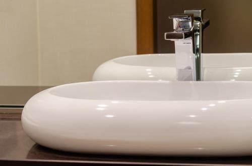a white sink with a faucet in a bathroom at TURIM Av. Liberdade Hotel in Lisbon