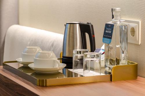 a tray with dishes and a bottle on a table at TURIM Av. Liberdade Hotel in Lisbon