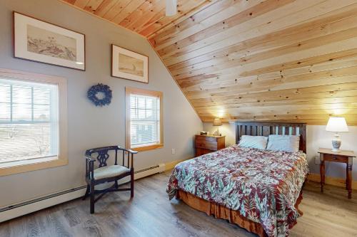 a bedroom with a bed and a wooden ceiling at Lobster Cove Retreat in Prospect Harbor