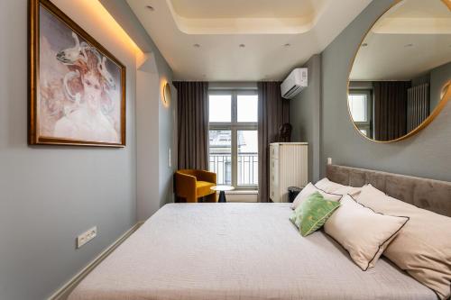 a bedroom with a large bed with a mirror on the wall at Art Boutique in Krakow
