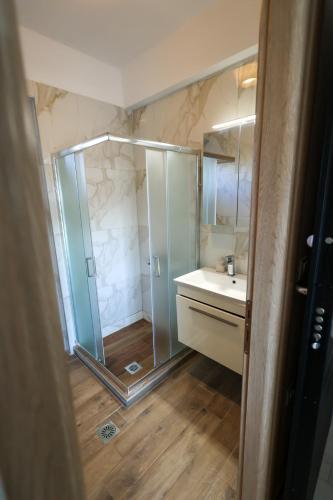 a bathroom with a shower and a sink at 4Keys Apartments Nikiti in Nikiti