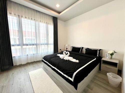 a bedroom with a bed with a white towel on it at Chokchai village 9 in Nong Prue