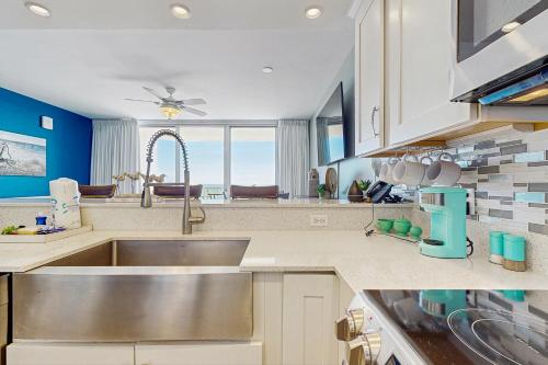 a kitchen with a sink and a large window at Beach Club C502 in Gulf Highlands