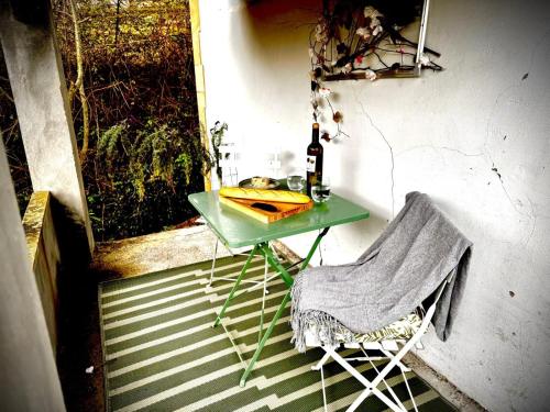 a green table and a chair on a porch at Morning Star La Lastra - St Ignatius House in La Lastra