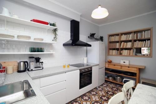 a kitchen with white cabinets and a counter top at Artistic elegant home in Afitos