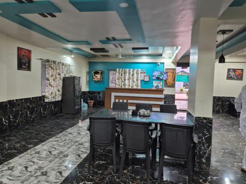 a dining room with a table and chairs at Tarasrushti lodge in Arvi