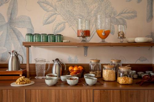a shelf with bowls and jars of food on it at Les Hayes en Sologne in Fontaines-en-Sologne