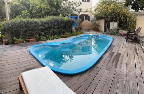 a blue swimming pool on a wooden deck at Vasilion Agrotourism in Polis Chrysochous
