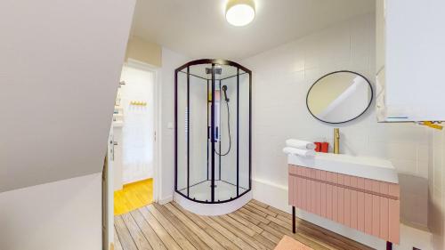 une douche dans une salle de bain avec un lavabo et un miroir dans l'établissement L'Écrin Cozy - Nancy Thermal - cité judiciaire 4 personnes, à Nancy