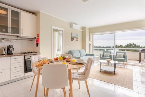 een keuken en eetkamer met een tafel en stoelen bij Ocean Bliss - Beach & BBQ Apartment in Viana do Castelo