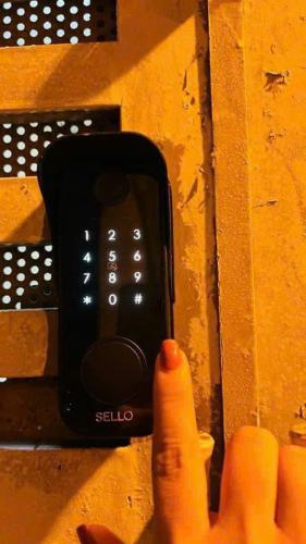 a hand is pointing at a cell phone on a wall at Studio Kéo lưới in Hanoi