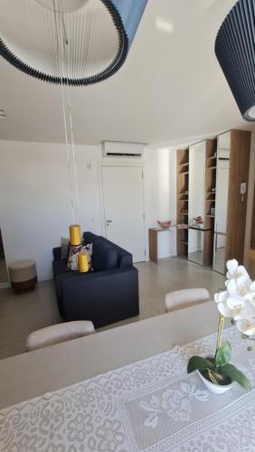 a living room with a blue couch and a table at Apartamento Familiar! in Pelotas