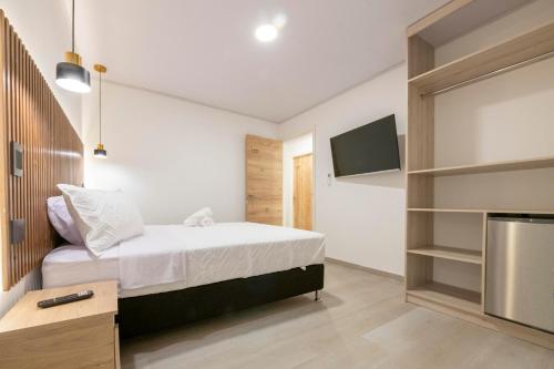 a bedroom with a bed and a flat screen tv at Hotel Blu Sai in San Andrés