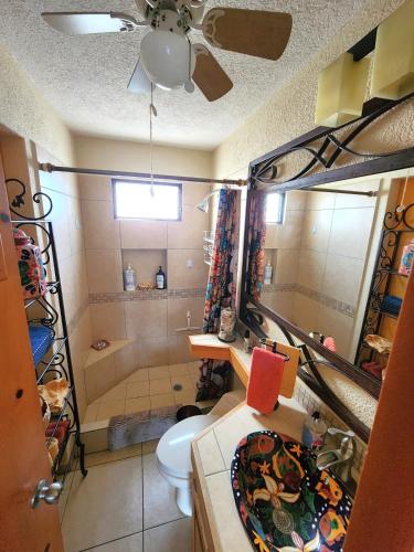 a bathroom with a shower and a toilet and a sink at Beach Eateries 10 min walk 1BDRM Golf view in San José del Cabo
