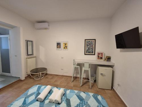 a living room with a bed and a table at Drin room in Catanzaro Lido