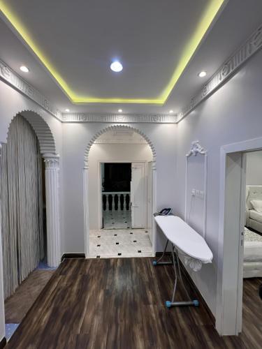 a room with a desk and a bed and a hallway at مسكن كازان in Abha