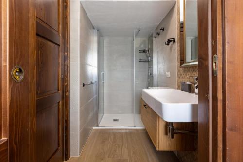 a bathroom with a white sink and a shower at GuestHost - Domus Ritae in Domus de Maria