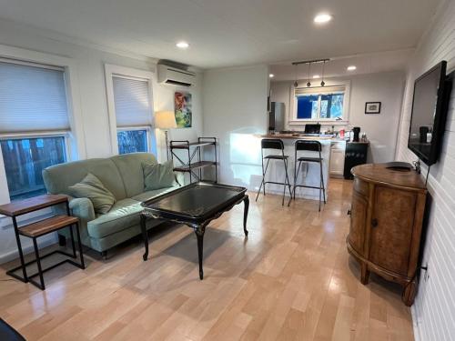 a living room with a couch and a table at East Side Blue Bonnet Cottage in Austin