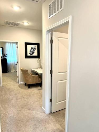a door leading into a room with a table at The Villas The One Villa by RDU Airport with Indoor Heated Pool and Gym in Durham