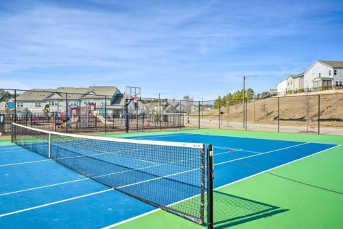 a tennis court with a net on it at The Villas The One Villa by RDU Airport with Indoor Heated Pool and Gym in Durham