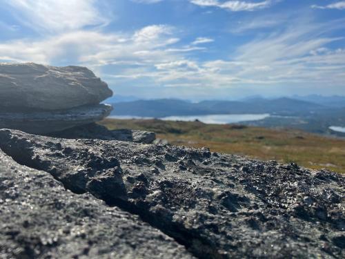 a pile of rocks sitting on top of a mountain at Cosy, modern apartment near the city center in Senja