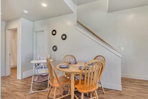 a dining room with a wooden table and chairs at Hill Field Stays by Cloud Dream Homes in Layton