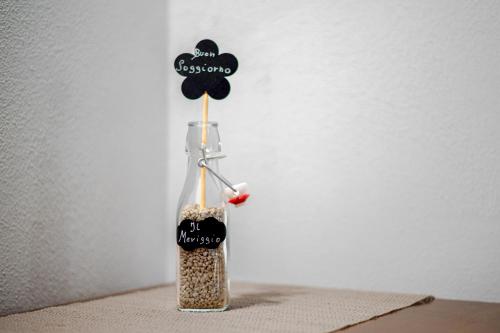 a glass bottle filled with seeds on a table at Agriturismo Meriggio in Semproniano