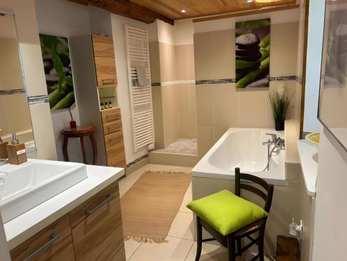 une salle de bain avec une baignoire blanche et un lavabo dans l'établissement L'ancienne Forge, à Villarzel-du-Razès