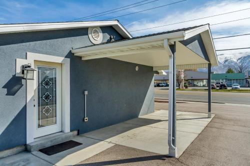 awning on the side of a blue building at Hill Field Stays by Cloud Dream Homes in Layton