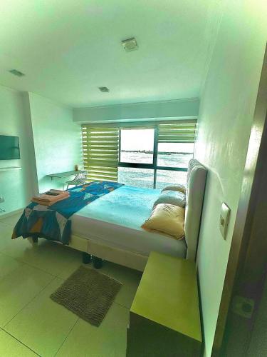 a bedroom with a large bed and a window at River view 6-04 in Guayaquil