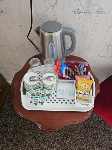 a table with a tray of food and a coffee maker at Castle By The Sea Scarborough in Scarborough