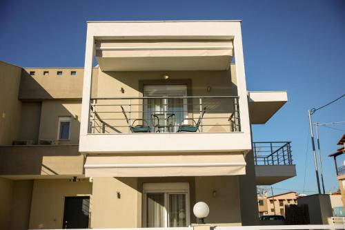 a building with a balcony with two chairs on it at 4Keys Apartments Nikiti in Nikiti