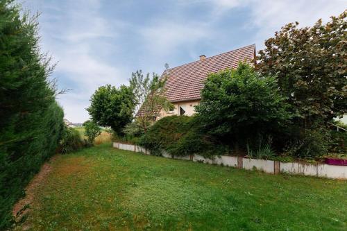 a house with a yard with trees and a fence at Charly's House - Parking et terrasse in Houssen